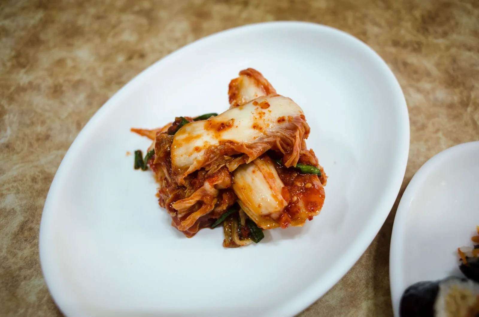 Kimchi served on a white plate