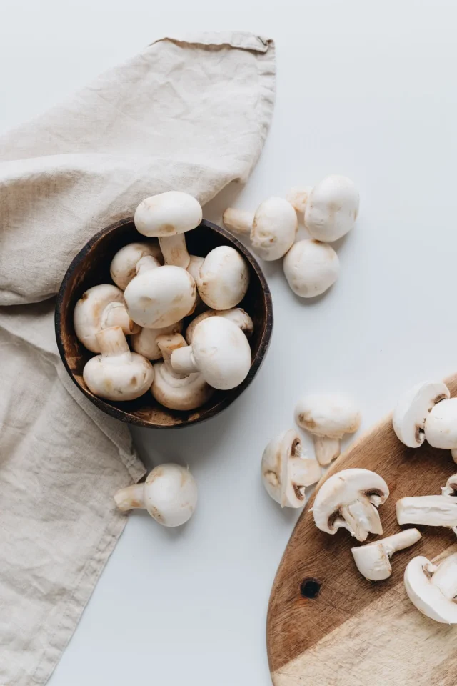 Fresh mushrooms in a wooden bowl