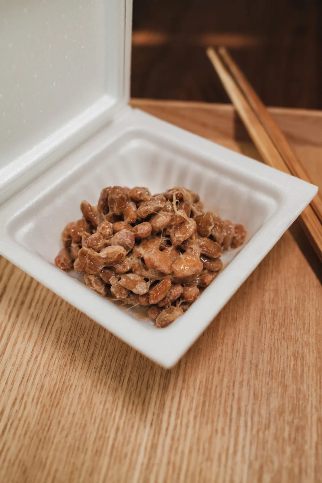 Prepared natto in a foam container with chopsticks