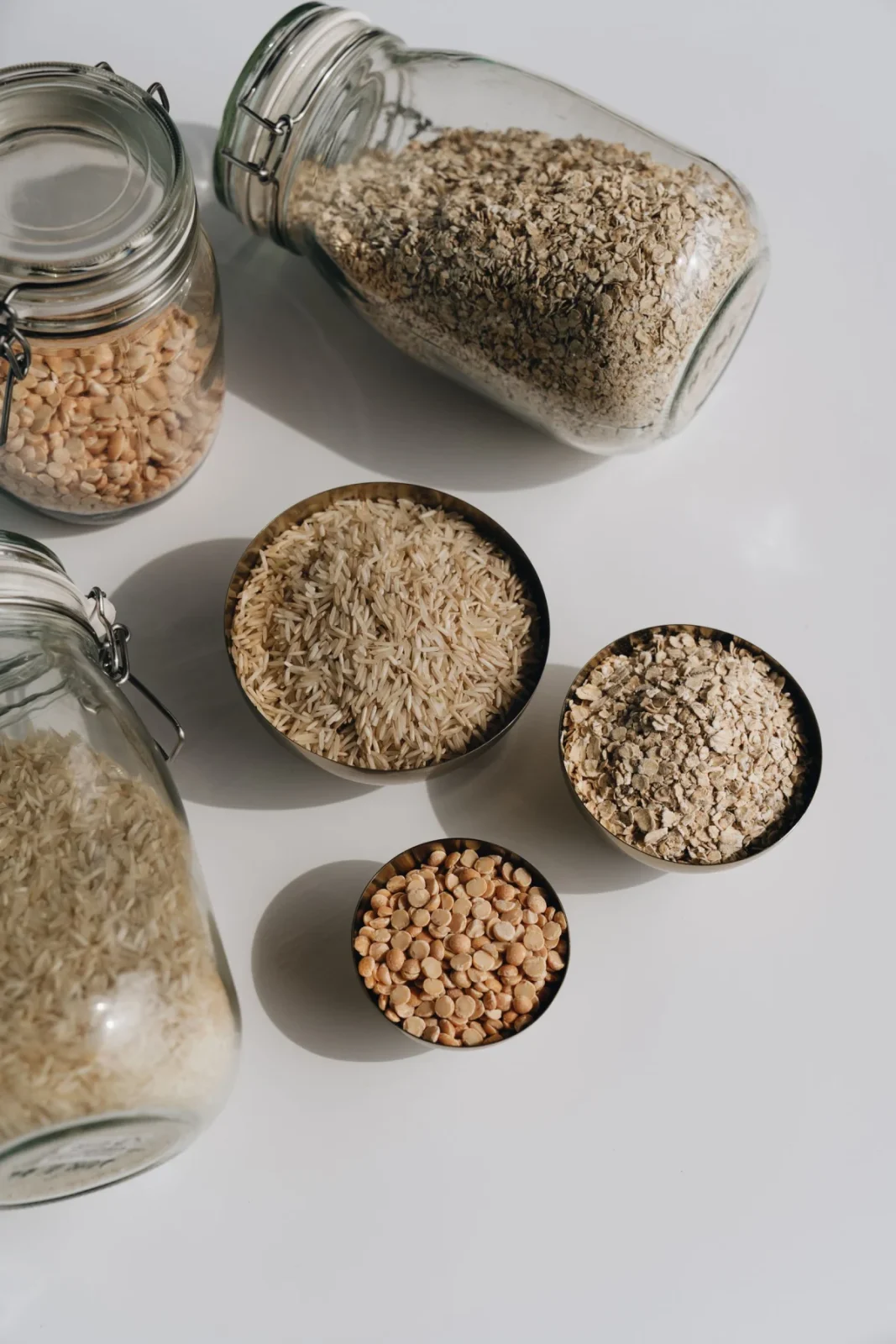 Dry ingredients arranged in glass jars and small bowls