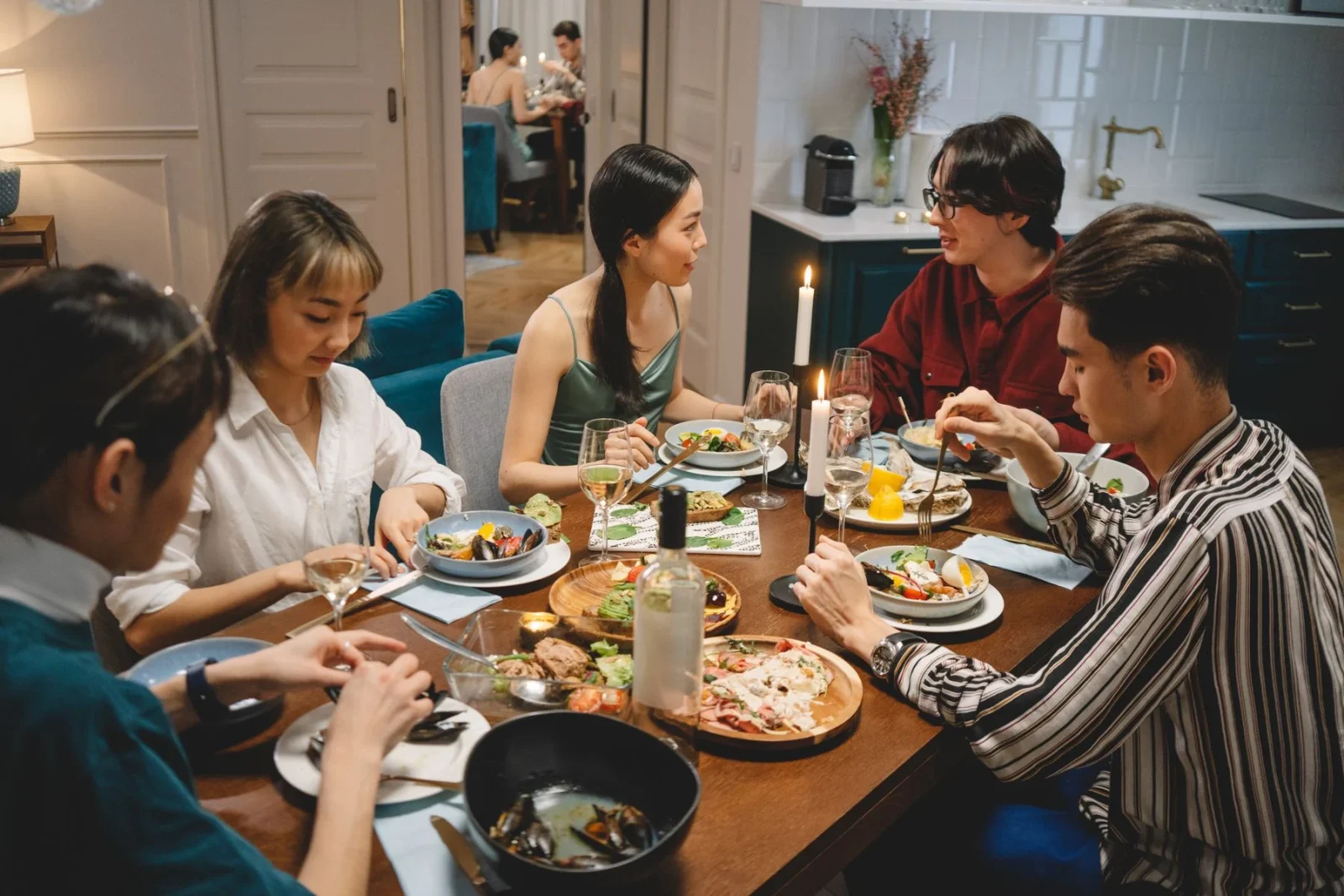 Friends sharing dinner in a warmly lit room